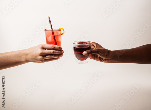 Two hands holing hot coffee and iced tea photo