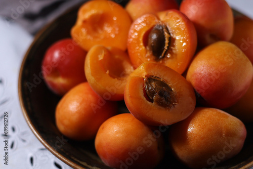 Fresh ripe apricots in bowl in rustic style