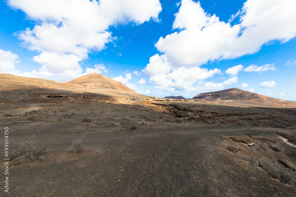 Spectacular view of the volcanic landscape in Timanfaya National Park. Lanzarote, Canary Islands, Spain, Atlantic, Europe. Tourism and vacations concept.