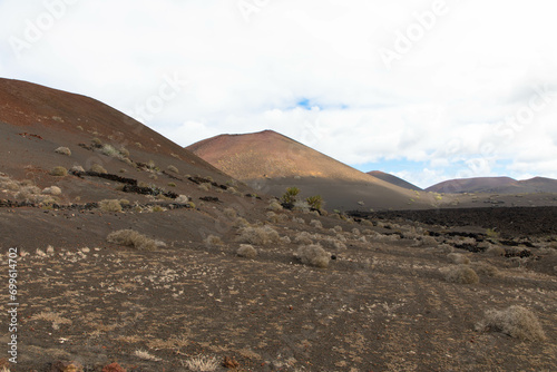 Spectacular view of the volcanic landscape in Timanfaya National Park. Lanzarote, Canary Islands, Spain, Atlantic, Europe. Tourism and vacations concept.