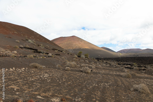 Spectacular view of the volcanic landscape in Timanfaya National Park. Lanzarote  Canary Islands  Spain  Atlantic  Europe. Tourism and vacations concept.