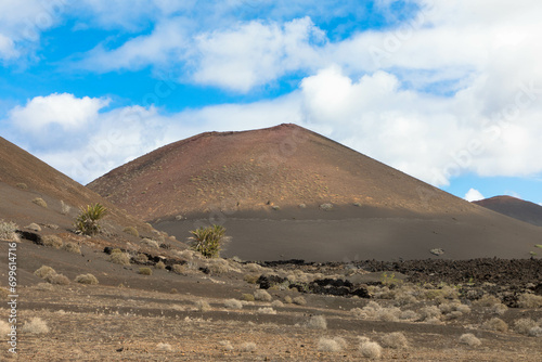 Spectacular view of the volcanic landscape in Timanfaya National Park. Lanzarote, Canary Islands, Spain, Atlantic, Europe. Tourism and vacations concept.