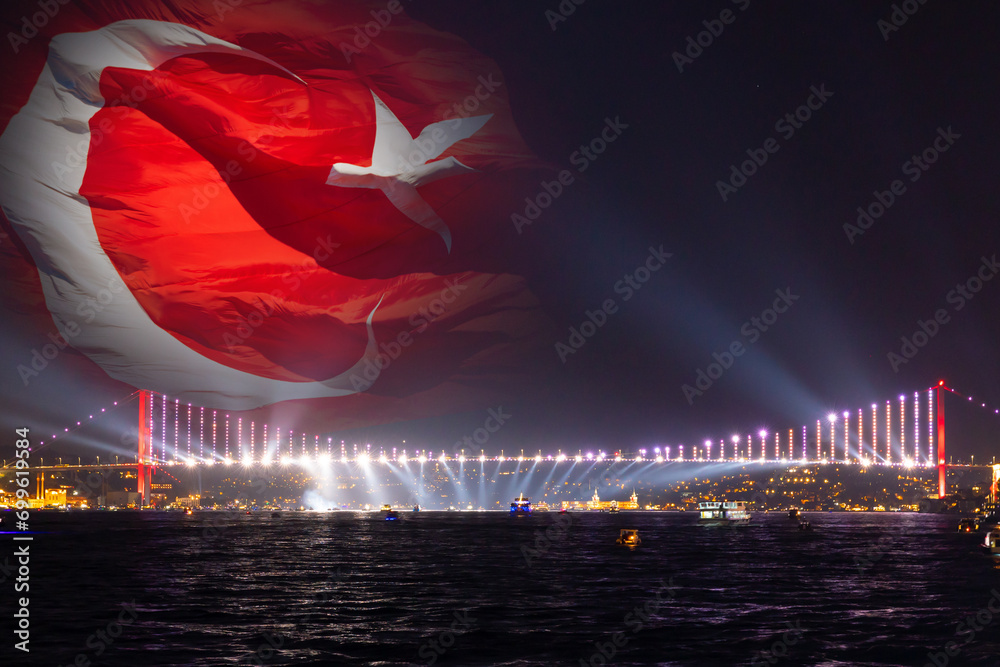 Bosphorus Bridge with spotlights and waving Turkish Flag