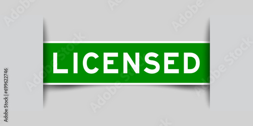 Inserted green color label sticker with word licensed on gray background