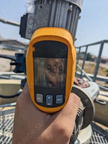 Check temperature of body motor agitator of sludge clarifier The photo is suitable to use for industry background photography, power plant poster and maintenance content media.