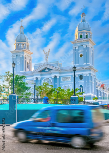 Blurred motion of vehicle by the Cathedral in Santiago de Cuba, Cuba photo