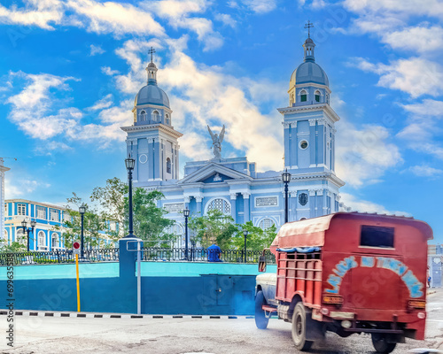 Blurred motion of vehicle by the Cathedral in Santiago de Cuba, Cuba photo