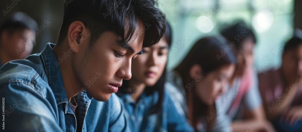 Asian man in group therapy session seeking psychological support, discussing life problems with diverse friend group, feeling upset, in pain, and dealing with depression.