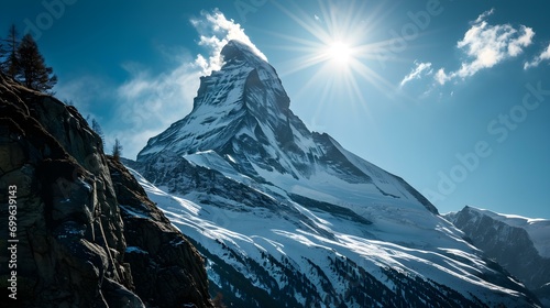 Majestic Alpine Snow-Covered Mountain Peak on a Sunny Day with Blue Sky