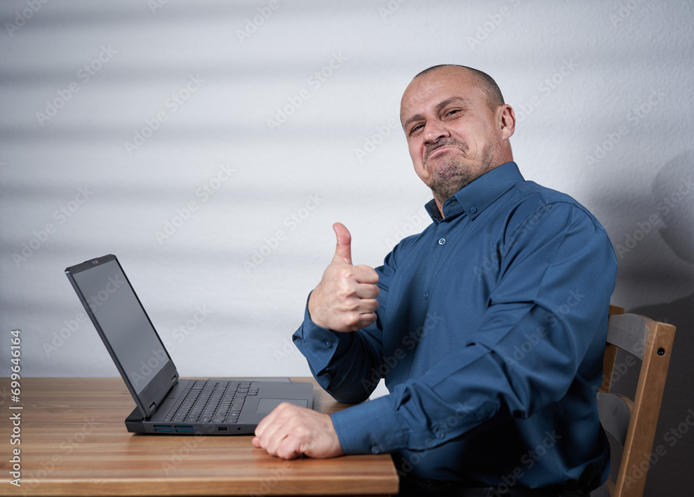 Mature businessman with laptop at his desk Mature businessman with laptop at his desk