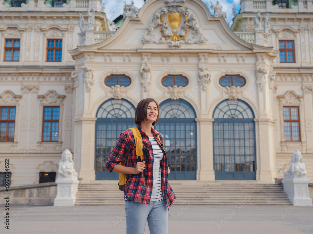 Female tourist traveling in Austria, capital city Vienna. summer female solo trip to Europe, happy young woman walking on european street.
