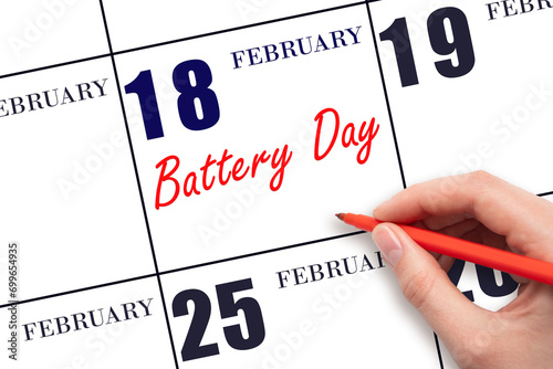 February 18. Hand writing text Battery Day on calendar date. Save the date. photo