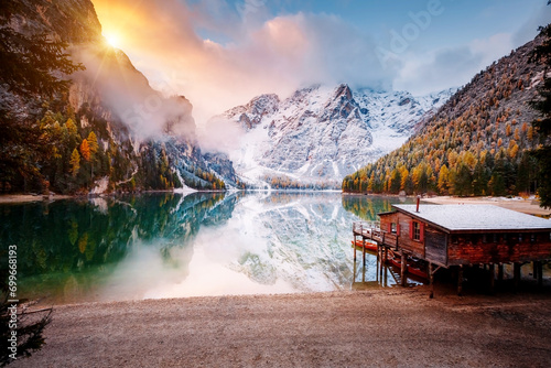Great view of the mighty rock above peaceful alpine lake Braies. National park Fanes-Sennes-Braies, Italy, Europe. photo