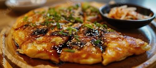 Korean pancake with enoki mushrooms, cheese, and tangy soy sauce. photo