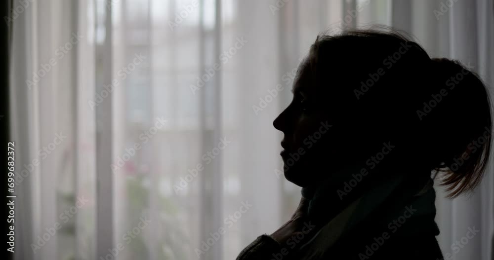 A woman with a sore throat sprays a medicinal aerosol spray down her throat A woman with a sore throat sprays a medicinal aerosol spray down her throat