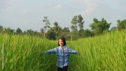 Young Girl in Rice Field: A young girl, lost in a vibrant rice field, explores the endless green landscape, representing the freedom of youth and the beauty of nature.