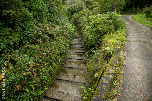 Walking the hiking road following the Nakasendo trail between Tsumago and Magome in Kiso Valley  Japan.