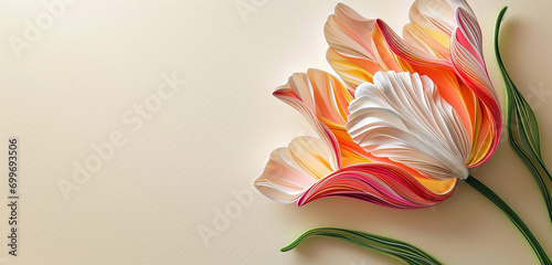 A vibrant quilling art piece showcasing a tulip with a color gradient from bright pink at the base to a delicate white at the tips. photo