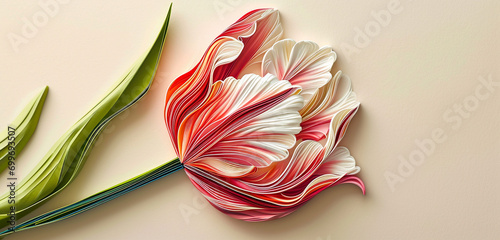 A vibrant quilling art piece showcasing a tulip with a color gradient from bright pink at the base to a delicate white at the tips. 