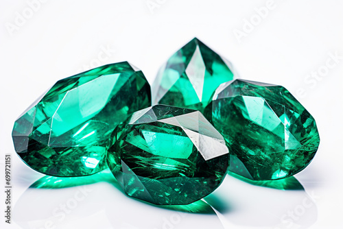Precious green emerald crystals on white background