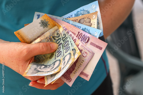 Hungary money, Woman holds a handful of Hungarian Forints in her hand, various banknotes, Financial concept photo