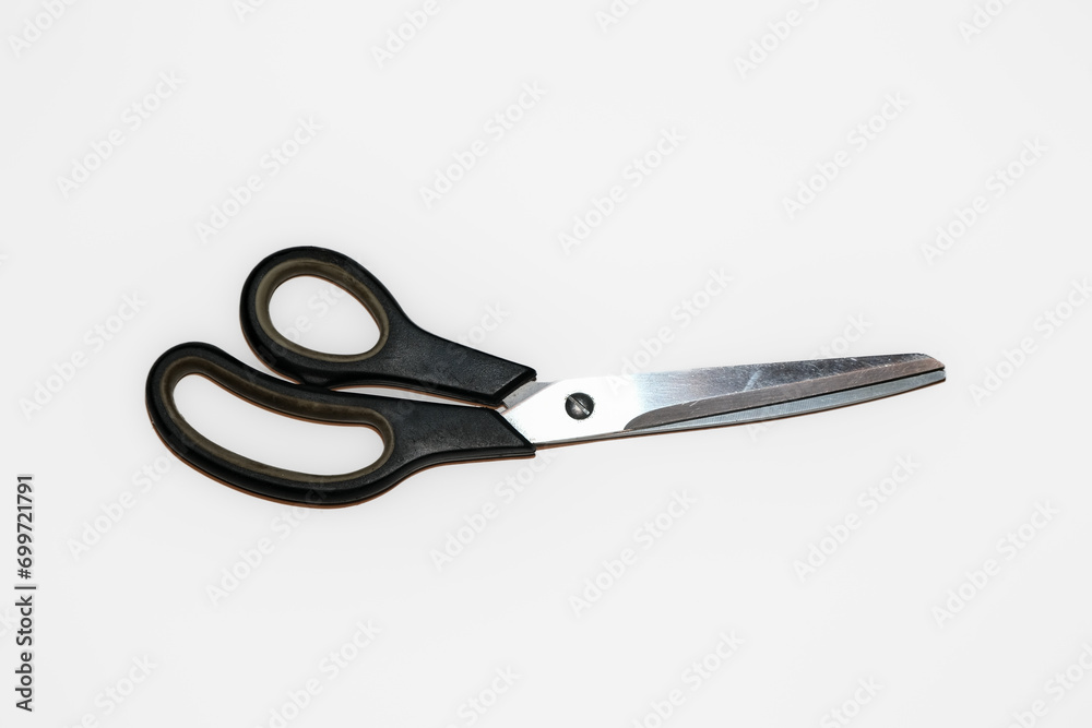 Pair of old used barber scissors with some scratches and dirt isolated on white background. Scissor blades are not open. Pair of old used barber scissors with some scratches and dirt isolated on white background. Scissor blades are not open.