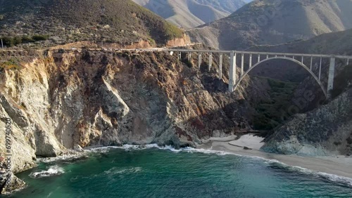 Aerial of the rugged coastline of Big Sur California. The Pacific Coast Highway and the famous Bixby Creek Bridge can be seen.
