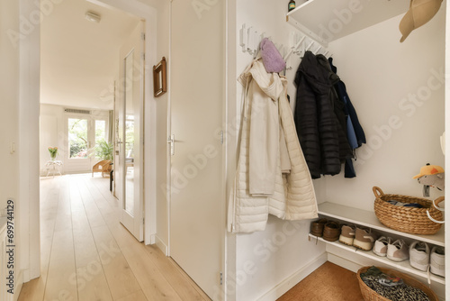 Empty hallway with coats and shoes at home photo