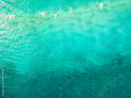 Serene ocean water view from above, photo taken by drone of the ocean, crystal clear waters of the beach