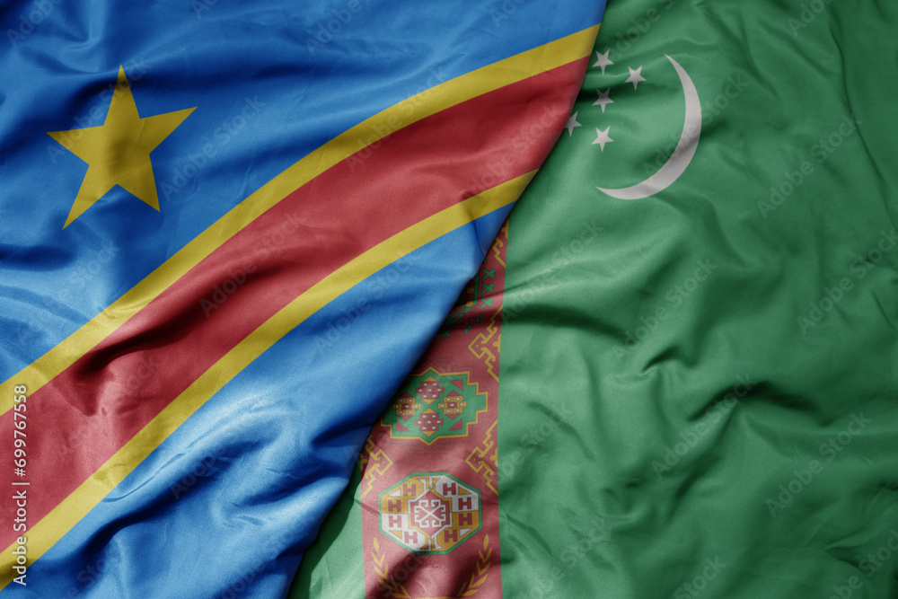 big waving national colorful flag of turkmenistan and national flag of democratic republic of the congo .