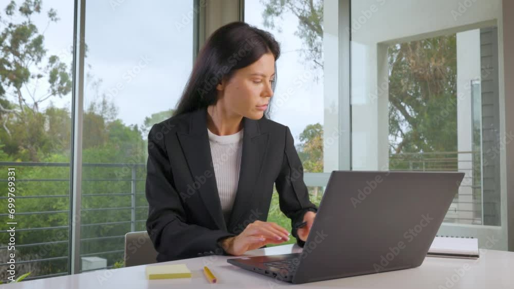 Woman working on her laptop while working from home. Woman working on her laptop while working from home.