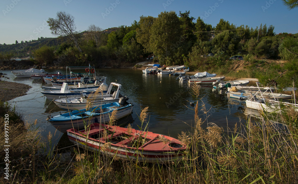 Sea bay at sunset for pleasure and fishing boats on the Kassandra peninsula on the Aegean Sea in Greece Sea bay at sunset for pleasure and fishing boats on the Kassandra peninsula on the Aegean Sea in Greece
