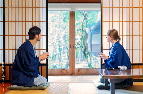 caucasian couple  drinking tea in tipical house  in Japan photo