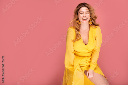 Fashion photo of natural smiling redhead woman with freckles in yellow dress
