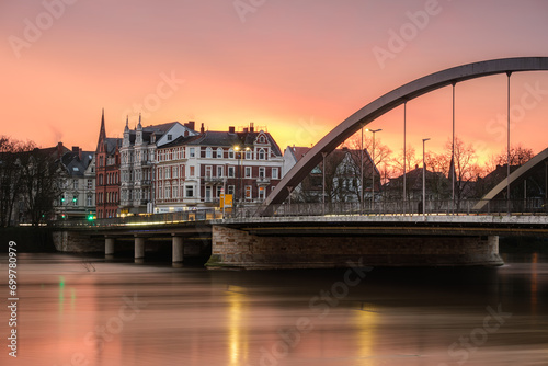 Sonnenaufgang an Weser in Minden bei Hochwasser mit Brücke photo