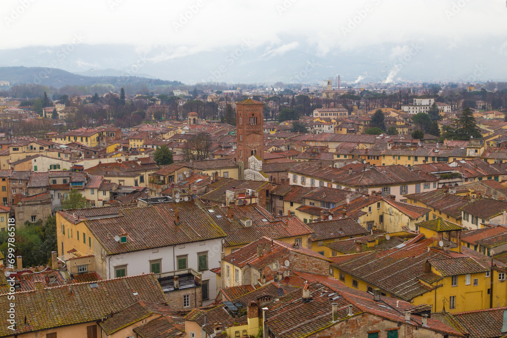 Tuscan Tapestry: Roofs of Red Under a Dramatic Sky