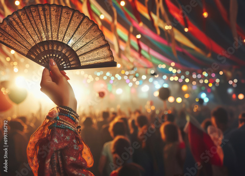 Woman's hand with a fan at the carnival.