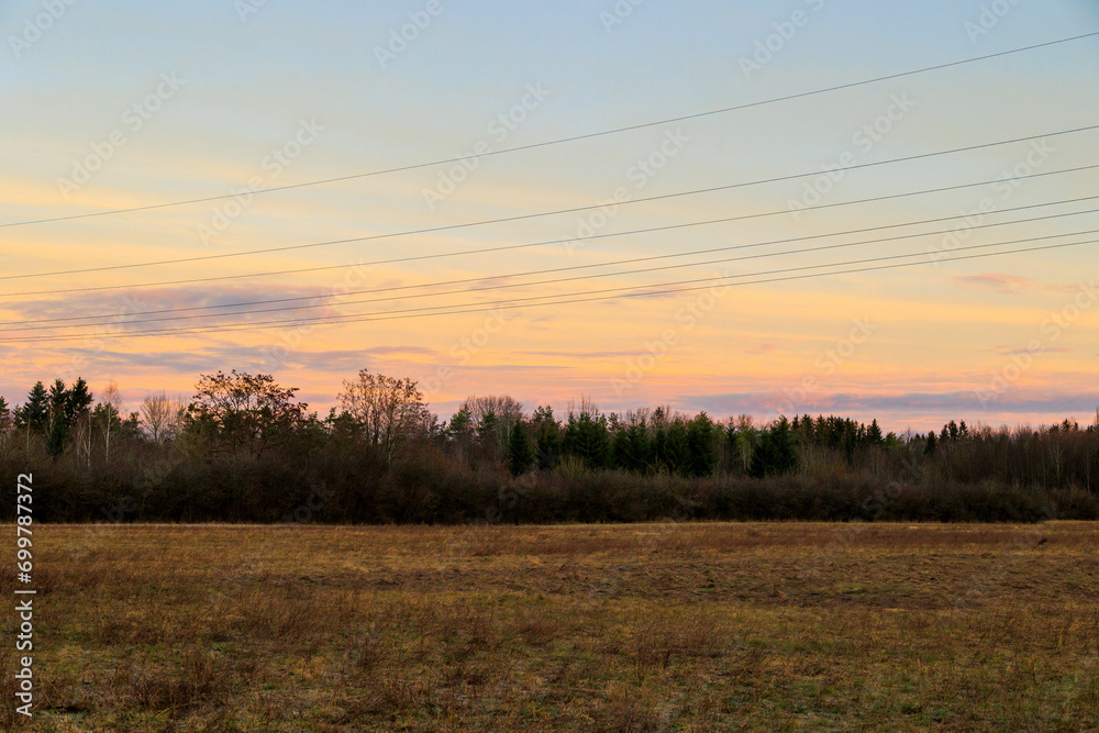 Colourful band of clouds in the morning sky over the fields and meadows of Siebenbrunn, the smallest district of the Fugger city of Augsburg Colourful band of clouds in the morning sky over the fields and meadows of Siebenbrunn, the smallest district of the Fugger city of Augsburg