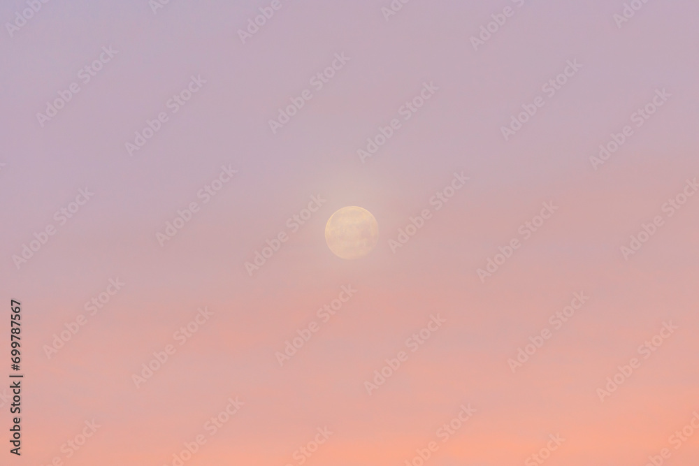 Slightly veiled full moon in the red sky above the houses of Siebenbrunn, the smallest district of the Fugger city of Augsburg Slightly veiled full moon in the red sky above the houses of Siebenbrunn, the smallest district of the Fugger city of Augsburg