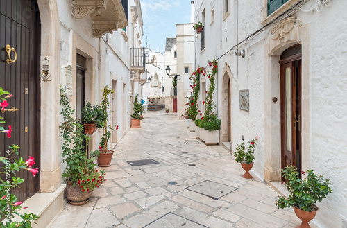 Fototapeta Naklejka Na Ścianę i Meble -  Characteristic narrow streets in the Locorotondo, metropolitan city of Bari, in Puglia, Italy