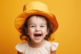 funny laughing girl in a hat, happy child, childrens day, grimaces and emotions