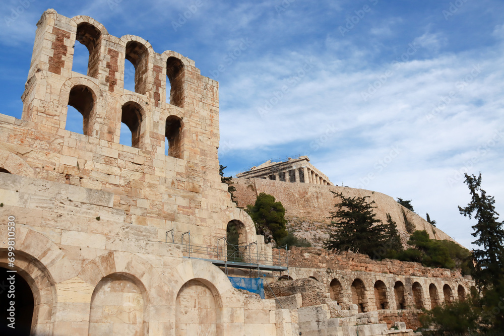 View of part of the Odeon of Herodes Atticus Theater foreground and the Parthenon in background