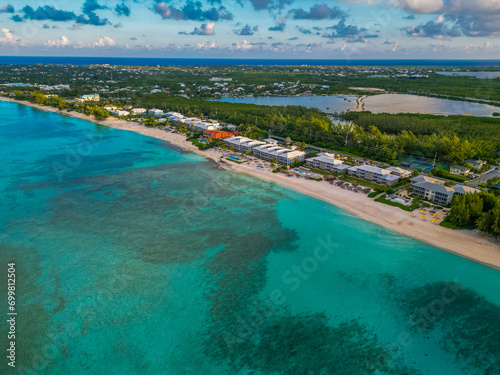 7 Seven Mile Beach Grand Cayman Cayman Islands pristine turquoise blue water white sand Caribbean sea Atlantic ocean hotels beachfront villas condos sunrise sunny day sky and clouds lush greenery © DELVIT