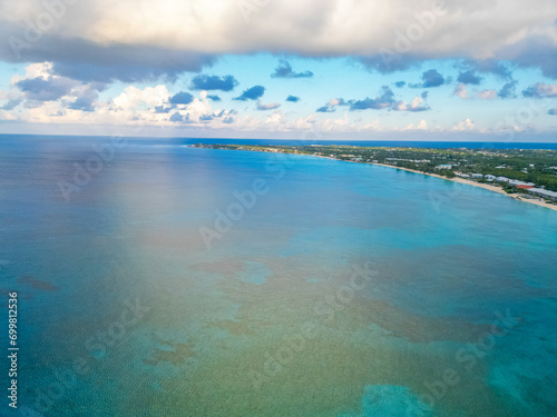 7 Seven Mile Beach Grand Cayman Cayman Islands pristine turquoise blue water white sand Caribbean sea Atlantic ocean hotels beachfront villas condos sunrise sunny day sky and clouds lush greenery