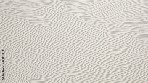  a close up of a white textured wallpaper with a black and white cat laying on top of it.