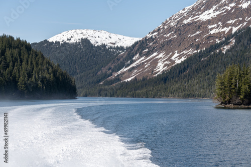 The wake of a boat and the mountains around Price William Sound, Alaska, USA