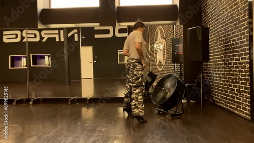Gay man dances in front of dance studio fan