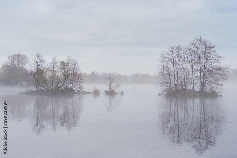 Island on a lake in thick fog, silhouette of the City. Island on a lake in thick fog, silhouette of the City.