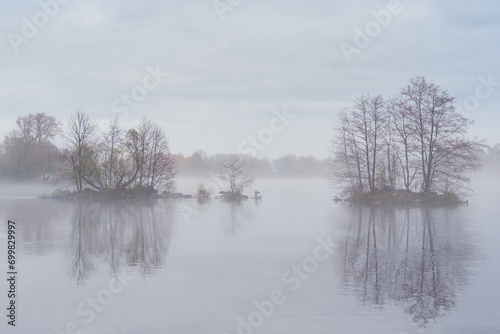 Island on a lake in thick fog, silhouette of the City.