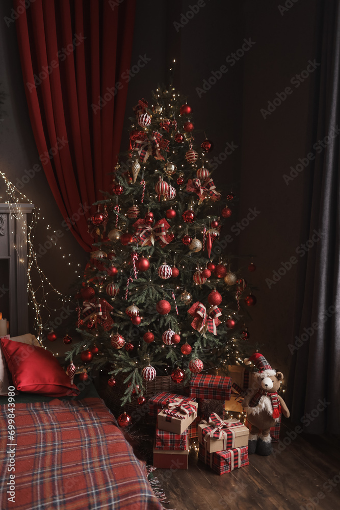 New Year and Christmas gifts under the tree in red paper.